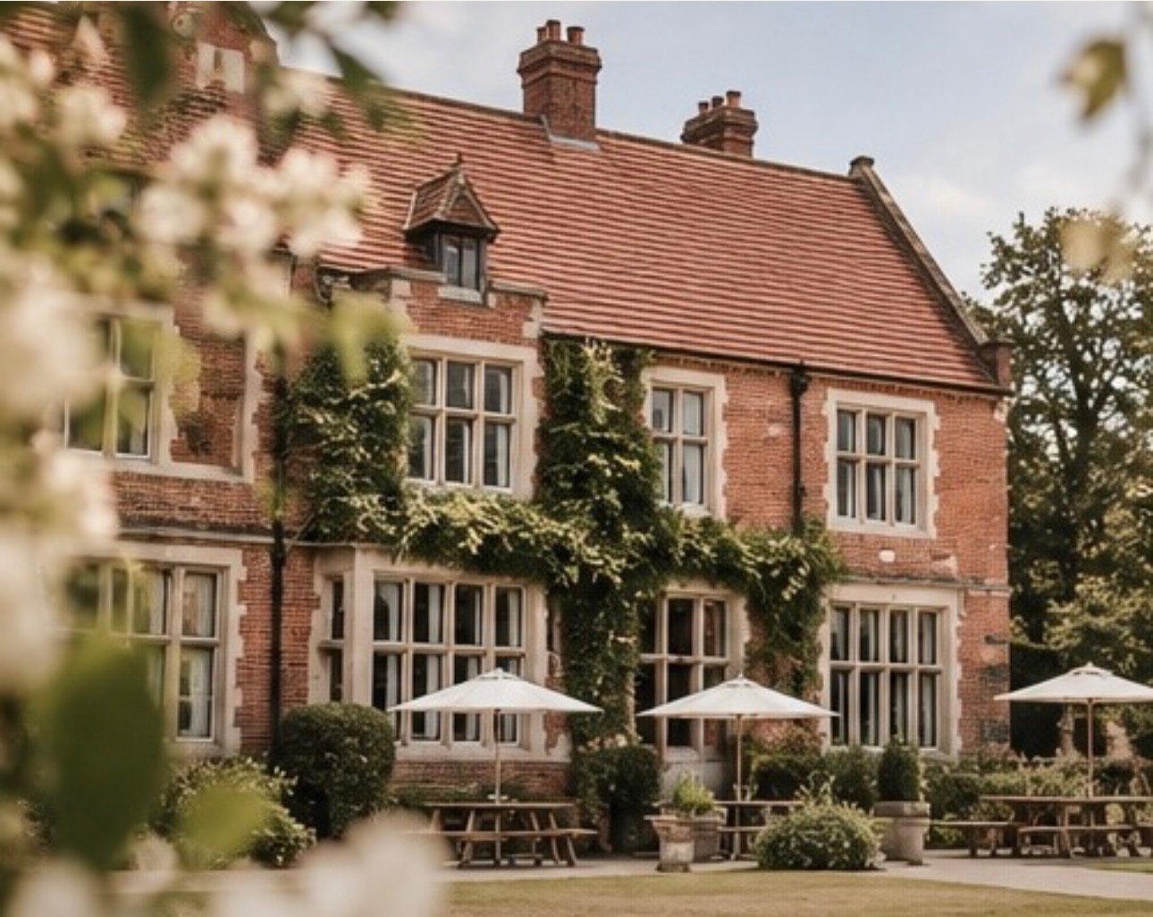 Highley Manor exterior with parasols and seating